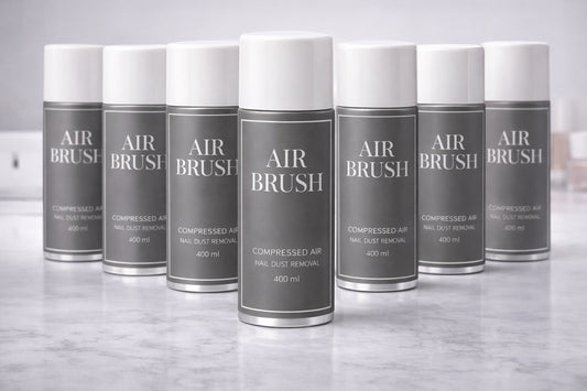 Kilka puszek AIR BRUSH ustawionych na marmurowym blacie w salonie